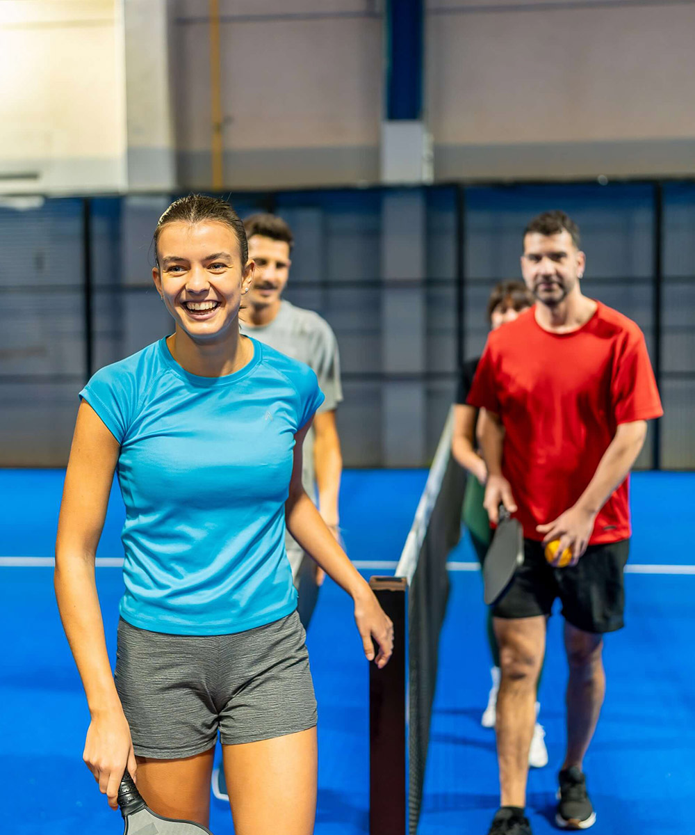 Kort padlowy indoor — ludzie grający w hali, nowoczesna konstrukcja